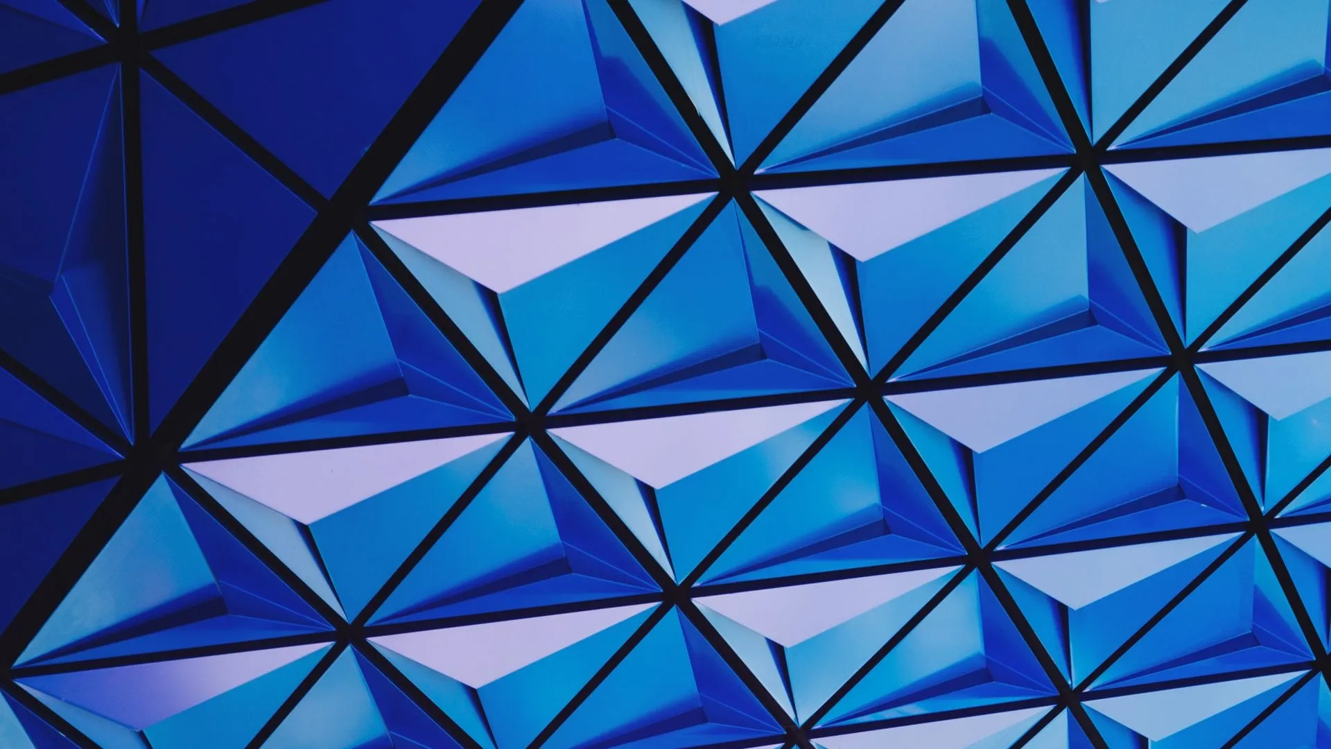 Vibrant blue geometric pattern with interlocking triangles.